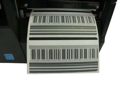 Zebra ZT230 industrial printer printing barcode label close up