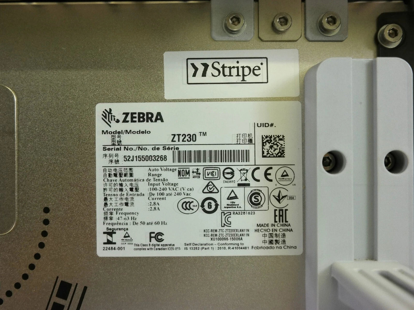 Zebra ZT230 printer serial number and compliance label inside housing