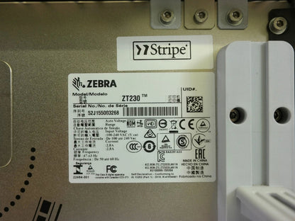Zebra ZT230 printer serial number and compliance label inside housing